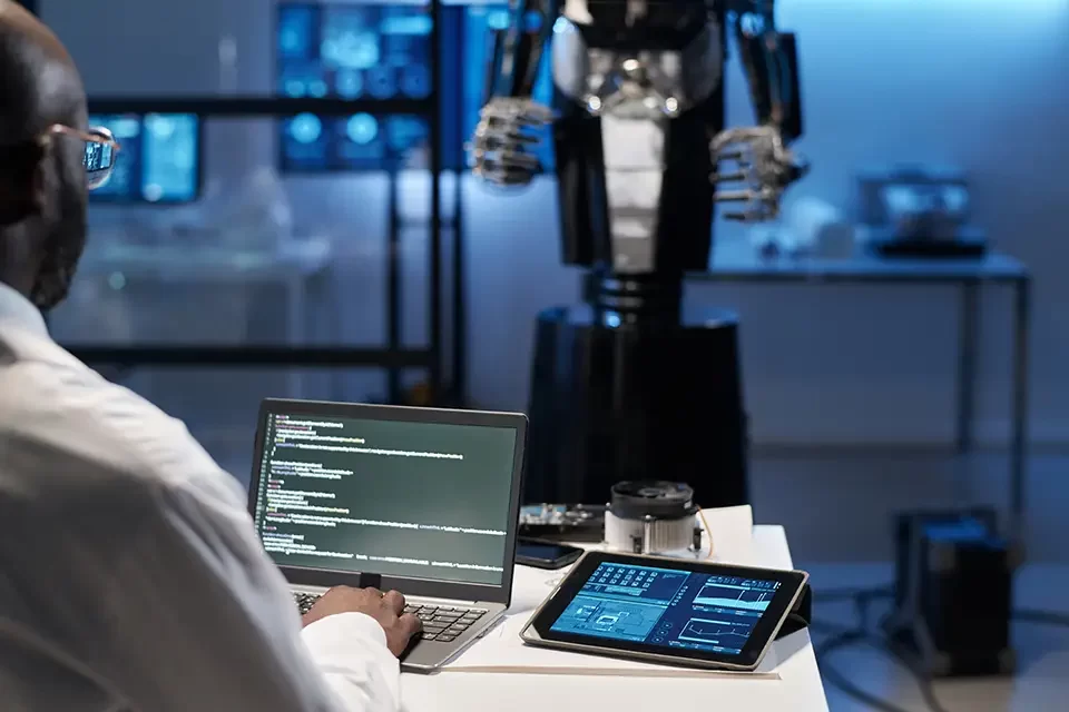 engineer-typing-security-codes-on-laptop IT Automation ROI: How Automation Delivers Tangible Business Value